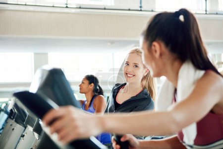 Photo for Wanna race. attractive young women working out on treadmills at the gym - Royalty Free Image