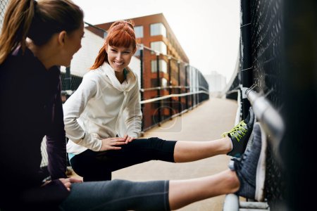 Photo for My legs are feeling it. two attractive young women stretching before their run in the city - Royalty Free Image