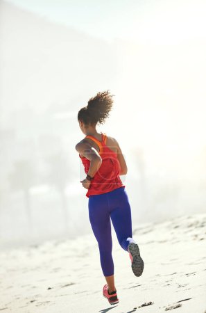Photo for Run until everything else disappears. a sporty young woman out for her morning run - Royalty Free Image