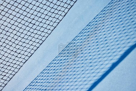 Photo for Nothing can substitute for just plain hard work. a tennis net on an empty court during the day - Royalty Free Image