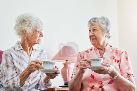 Photo for Those catch up sessions are golden. two happy elderly women having tea together at home - Royalty Free Image