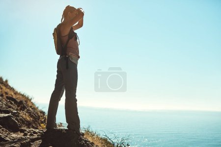 Photo for What a great big world there is to explore. a young woman admiring the view from the top of a mountain - Royalty Free Image