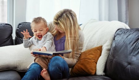 Photo for He gets so excited when its reading time. a young woman reading to her little boy - Royalty Free Image