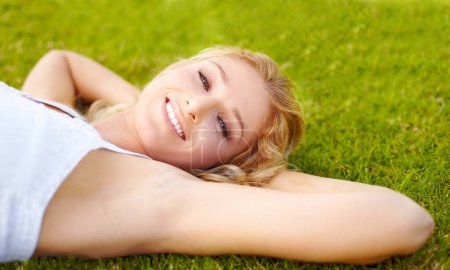 Photo for Portrait, relax and a woman lying on grass outdoor in nature during summer for peace or quiet on a field. Spring, garden and freedom with a young person relaxing outside on countryside green ground. - Royalty Free Image