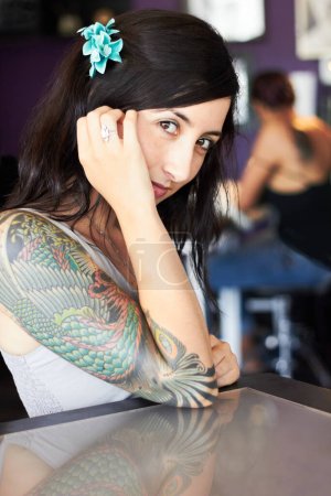 Photo for Creative, tattoo and portrait of woman in parlor for body art, design and creativity in ink shop. Tattoos, artist and face of female person with flower in hair for natural beauty, cosmetics and smile. - Royalty Free Image