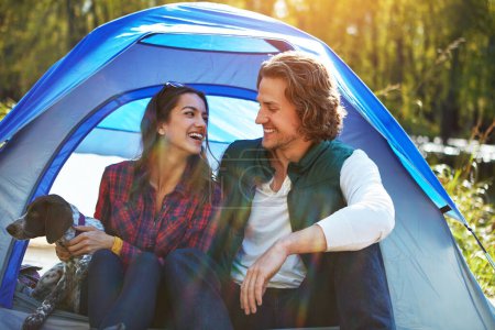 Photo for We all have different definitions of romance. an adventurous couple out camping with their dog - Royalty Free Image