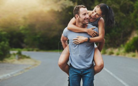 Photo for Where theres love, youll never walk alone. a happy young couple enjoying a piggyback ride outdoors - Royalty Free Image