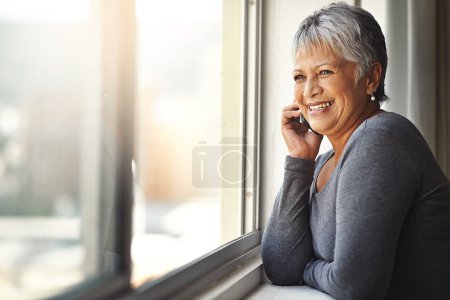Photo for Phone call, happy and senior woman talking, speaking and chat on mobile conversation, discussion or networking. Communication, window and relax elderly person talk to smartphone contact. - Royalty Free Image