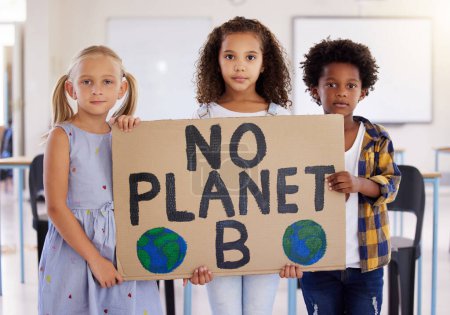Photo for Kids, portrait and poster with friends in protest in a classroom holding a sign for eco friendly activism. Children, green and a kindergarten group standing together for community or ecology. - Royalty Free Image