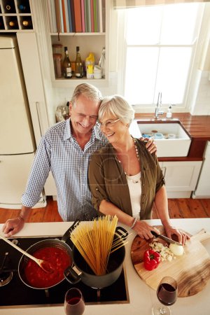 Foto de Cocinar con amor proporciona alimento para el alma. una pareja cocinando una comida juntos en casa - Imagen libre de derechos