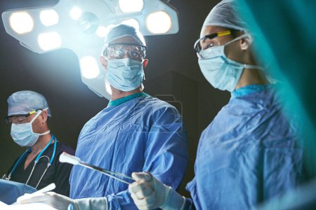 Photo for Experts in saving lives. surgeons in an operating room - Royalty Free Image