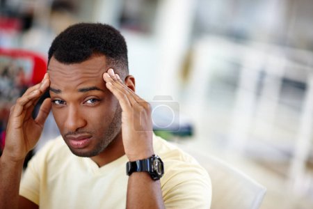 Photo for I need a holiday. a handsome young man suffering from a headache at work - Royalty Free Image
