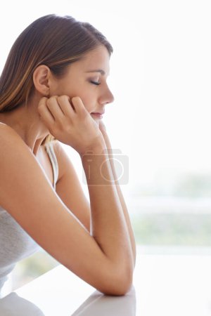 Photo for She has a lot on her mind. Profile shot of an attractive young woman looking thoughtful - Royalty Free Image