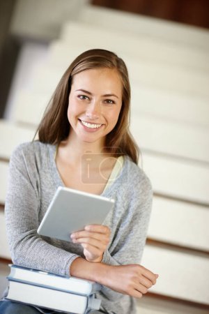 Photo for The calm before the study storm. A young woman using a digital tablet at home - Royalty Free Image