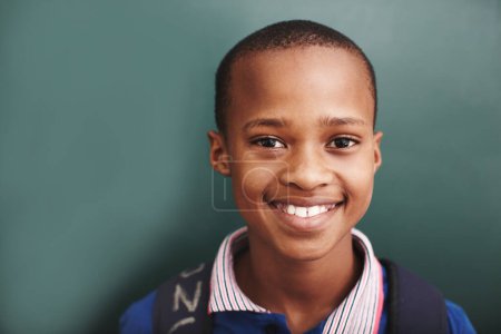 Photo for Hes the bright star in his classroom. An african american boy standing alongside copyspace at the blackboard - Royalty Free Image