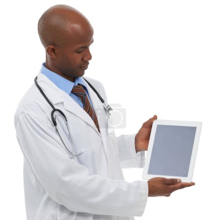 Photo for Looking at your healthcare message. Studio shot of a male doctor looking at the blank screen of a digital tablet that is reserved for copyspace - Royalty Free Image