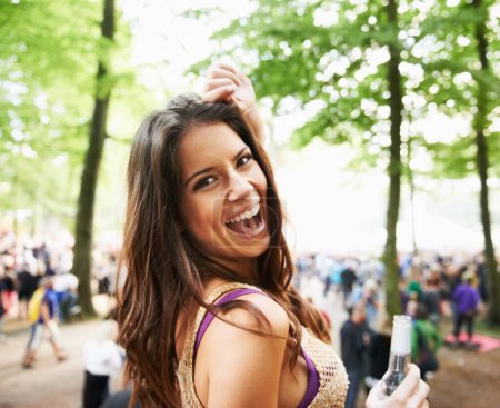 Photo for Moving to the music. A pretty young woman enjoying herself at an outdoor music festival - Royalty Free Image