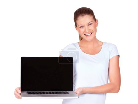Photo for Do yourself a favour and buy this. A lovely young woman presenting a top of the line laptop to you - isolated - Royalty Free Image