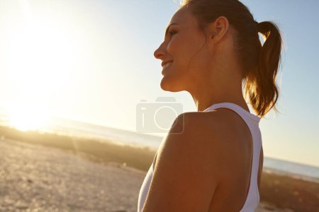 Photo for Taking it all in. Profile shot of a beautiful woman in sportswear admiring the view - Royalty Free Image