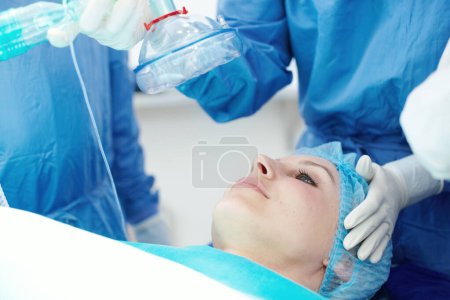 Photo for Putting you to sleep. A female patient going under general anaesthetic in a hospital - Royalty Free Image