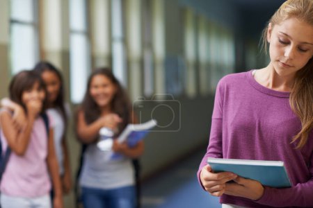 Photo for Bullying happens everywhere. A young girl getting teased at school - Royalty Free Image