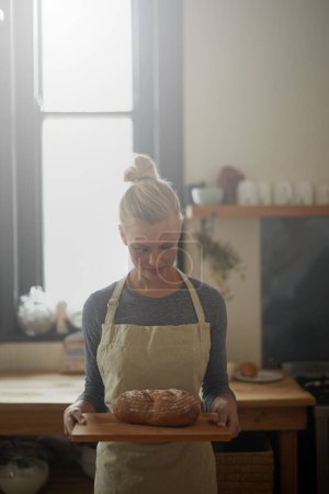 Téléchargez les photos : Le pain parfait. une jeune boulangère avec du pain maison - en image libre de droit