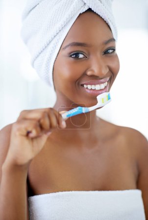 Photo for This toothpaste protects my pearly whites. a beautiful young woman during her daily beauty routine - Royalty Free Image
