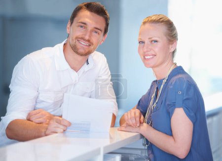 Photo for Were feeling pretty good about this contract. two coworkers looking over paperwork in the office - Royalty Free Image