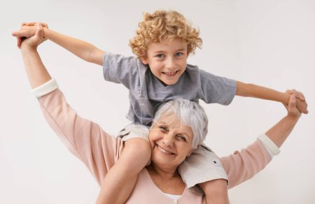 Photo for Portrait, airplane and grandmother with child embrace, happy and bonding against wall background. Love, face and senior woman with grandchild having fun playing, piggyback and enjoying game together. - Royalty Free Image