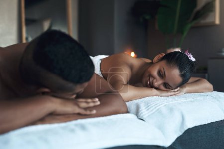 Topping off their honeymoon with a relaxing massage. a young couple relaxing on massage beds at a spa