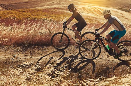 Photo for Love is sharing your favorite sport with someone. two cyclists out cycling in the countryside - Royalty Free Image