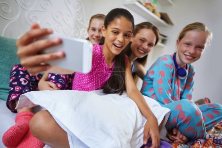 Photo for One...two...three...smile guys. a group of teenage friends taking a selfie together during a sleepover - Royalty Free Image