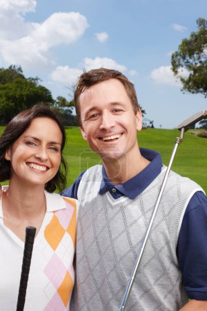 Photo for Golfing is something they both enjoy. Happy couple out on the golf course together - Royalty Free Image