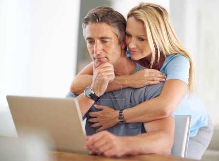 Photo for Social networking is for any age. a happy mature couple using a laptop at home - Royalty Free Image