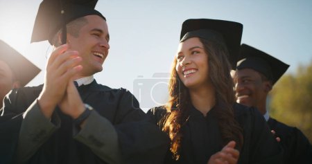 Photo for We actually made it to the top. a group of cheerful young students standing together while clapping their hands on graduation day outside during the day - Royalty Free Image