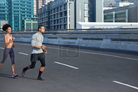 Photo for Just a step faster. two friends jogging together through the city streets - Royalty Free Image