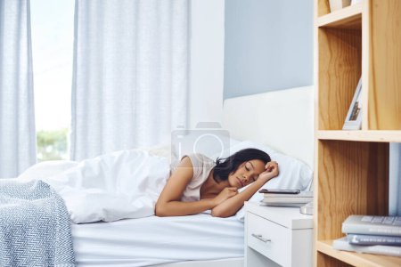Photo for Its the weekend and you know what that means. a young woman sleeping peacefully in her bed at home - Royalty Free Image
