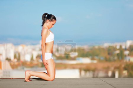 Photo for Woman, yoga and stretching body on roof top for exercise, zen workout or fitness outdoors. Female yogi in warm up stretch for healthy wellness, training or balanced lifestyle outside town on mockup. - Royalty Free Image