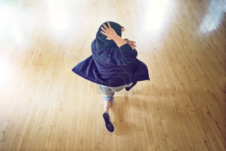 Téléchargez les photos : Au sommet de son jeu de danse. Plan grand angle d'un jeune homme breakdance dans un studio - en image libre de droit