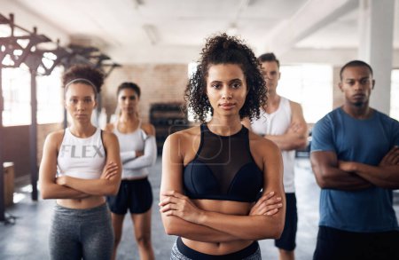 Photo for Ready Lets go. Portrait of a group of confident young people working out together in a gym - Royalty Free Image