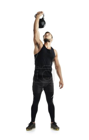Photo for Getting in a total body workout. Studio shot of a fit young man working out with a kettle bell against a white background - Royalty Free Image