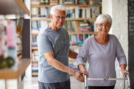 Photo for Step by step. Portrait of a senior man assisting his wife whos using a walker for support - Royalty Free Image