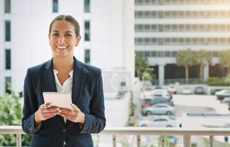 Photo for Shes got business covered. Portrait of a young businesswoman using a digital tablet on her way to the office - Royalty Free Image