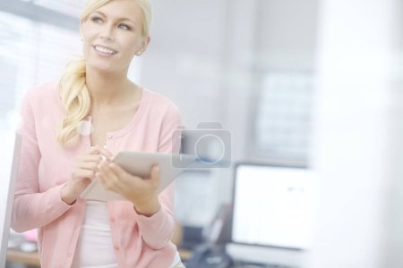 Photo for How should I say this...an attractive young businesswoman using a digital tablet - Royalty Free Image