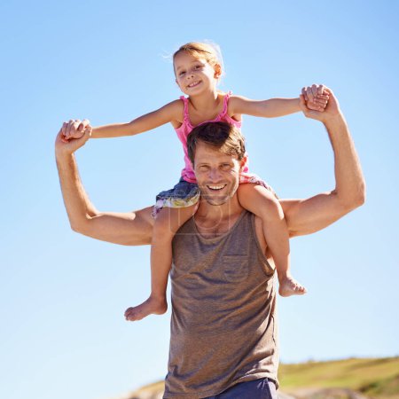 Photo for Shes on top of the world. Portrait of a handsome man giving his daughter a piggyback ride in the outdoors - Royalty Free Image