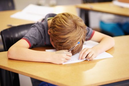 Photo for Sleeping, bored and tired with boy in classroom for learning, education and knowledge. Stress, anxiety or confused with male student at desk in school adhd for exhausted, autism problem or frustrated. - Royalty Free Image