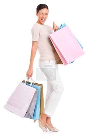 Photo for Have I got something for you. An attractive young woman carrying many shopping bags in both hands - Royalty Free Image