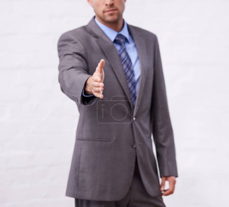 Photo for Youve been doing a great job. A confident businessman offering you his hand to seal the deal - Royalty Free Image