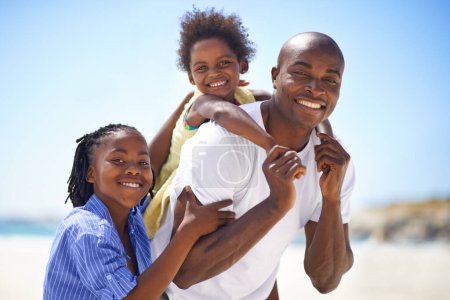 Photo for Our dad is the best. A father spending some time with his children on the beach - Royalty Free Image