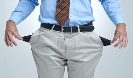 Photo for The recession has hit him hard. a businessman showing you his empty pockets - Royalty Free Image